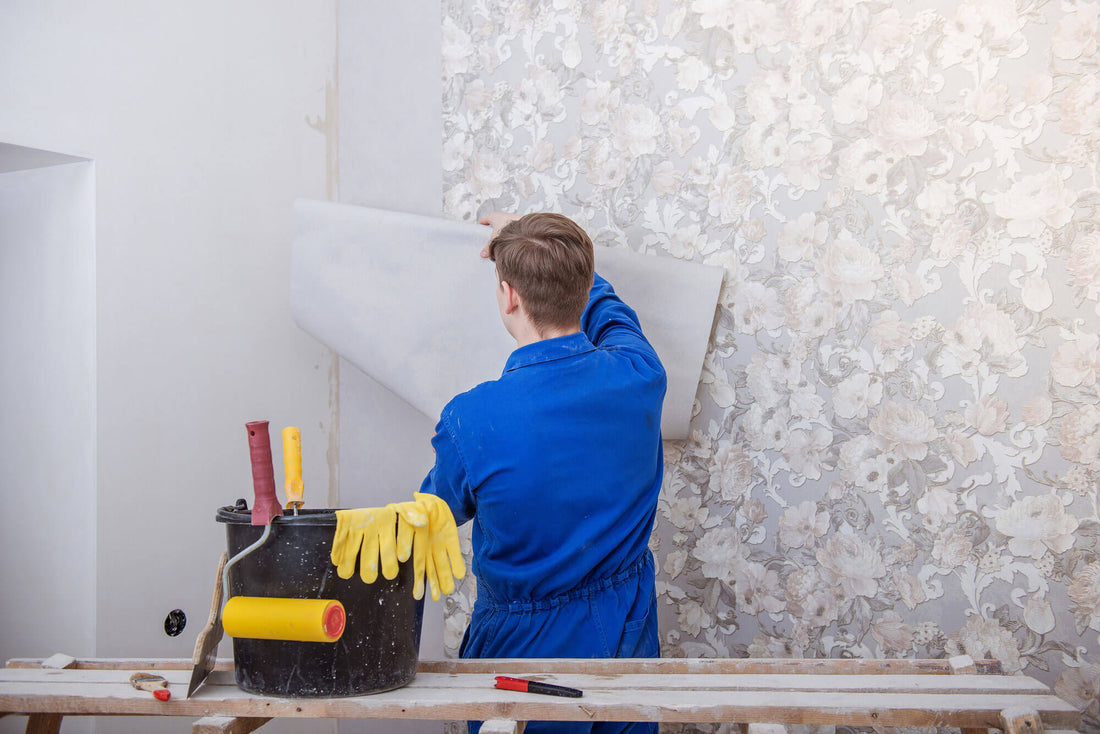 Wallpaper installer working in a room with patterned wallcovering