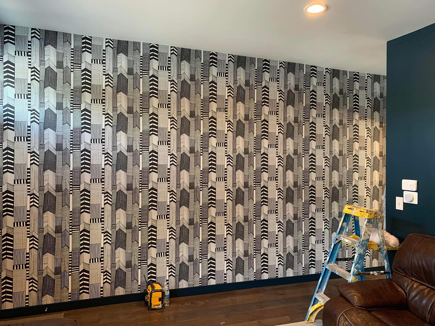 Installer carefully applying wallpaper to a wall